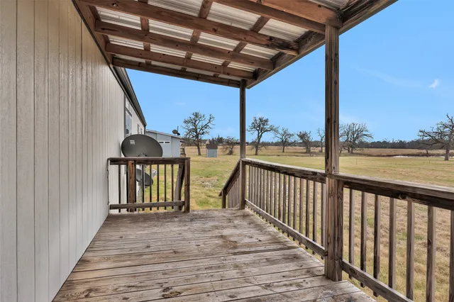 a view of a balcony with wooden floor
