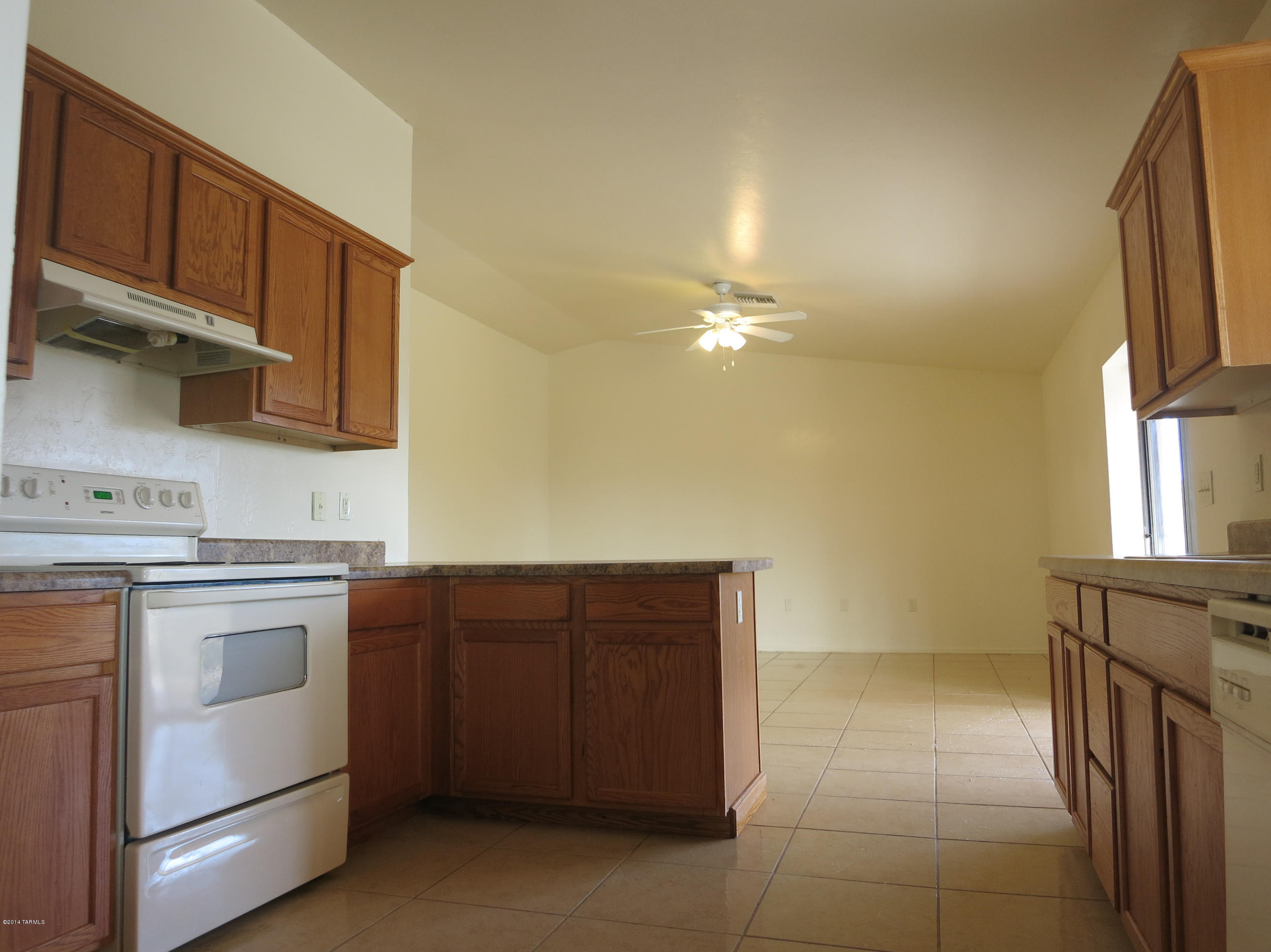 1055 Ameca Court Rio Rico, AZ 85648 - Photo 7 of 18 a kitchen with a cabinets and a stove top oven