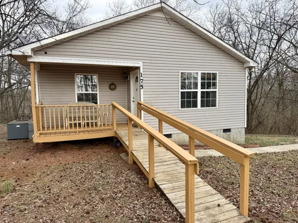 a view of a house with wooden fence