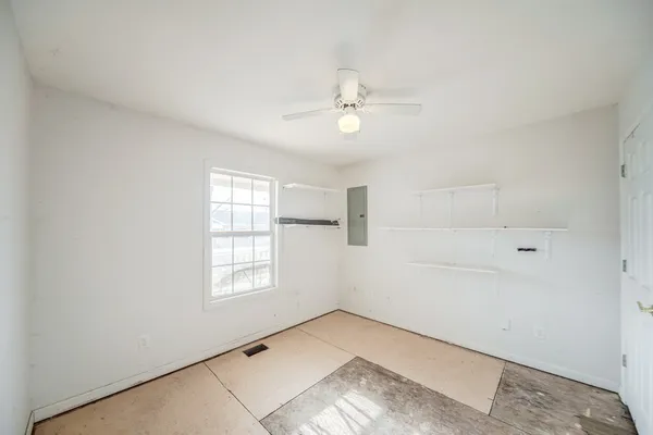 a view of a livingroom with a ceiling fan and window
