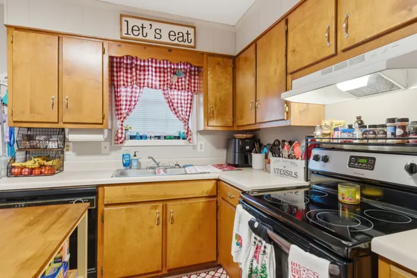 a kitchen with stainless steel appliances granite countertop a sink stove and cabinets
