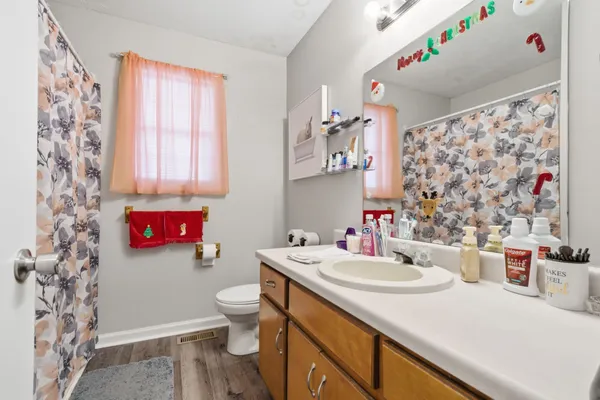 a bedroom with bed and a chandelier