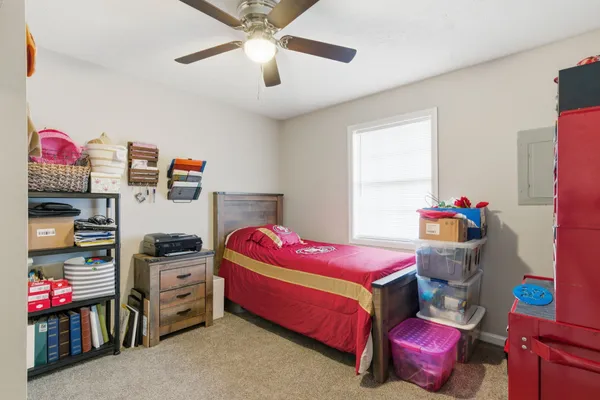 a bedroom with a bed and a dresser