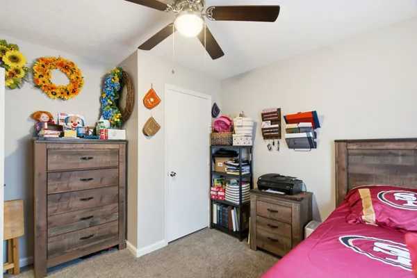 a bedroom with bed and a flat screen tv