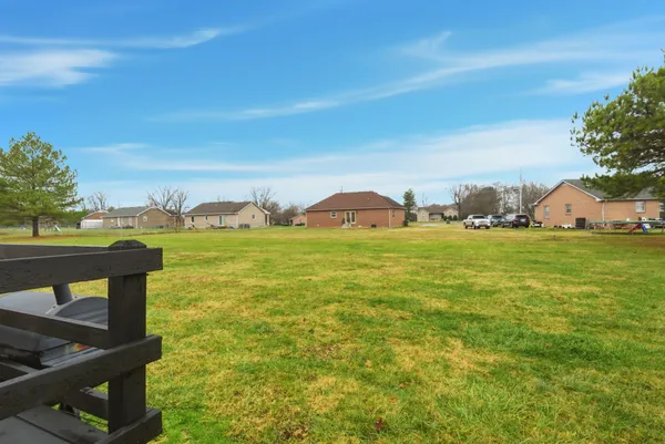 a backyard of a house with table and chairs