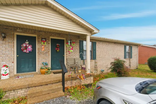 a front view of a house with outdoor seating