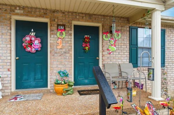 a living room with furniture and flowers