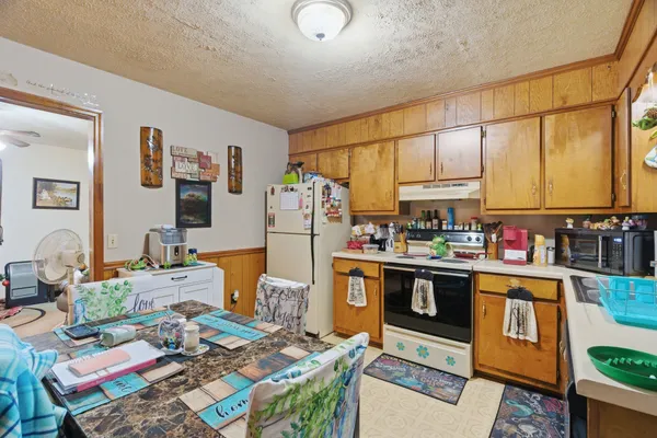 a kitchen with a sink stove and cabinets