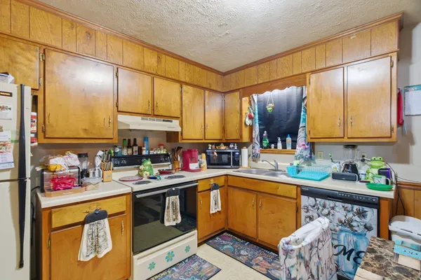 a open kitchen with stainless steel appliances granite countertop a sink and cabinets