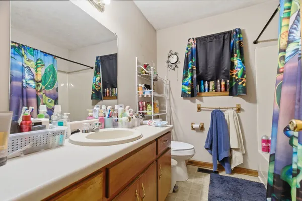 a bedroom with furniture and a flat screen tv