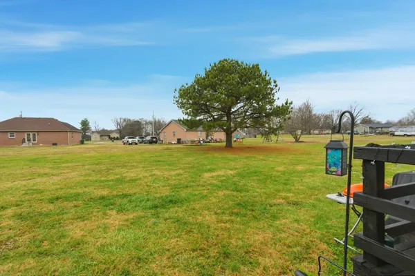 a view of a porch with chairs and garden