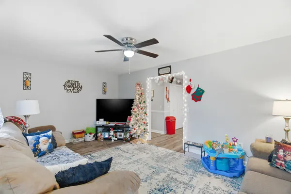 a bedroom with furniture and a flat screen tv