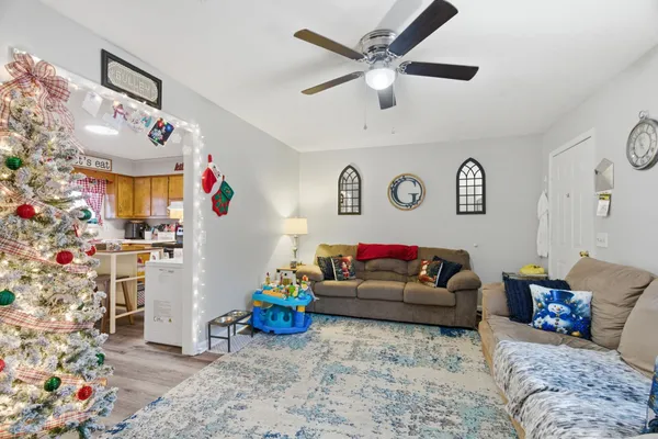 a living room with furniture and flowers