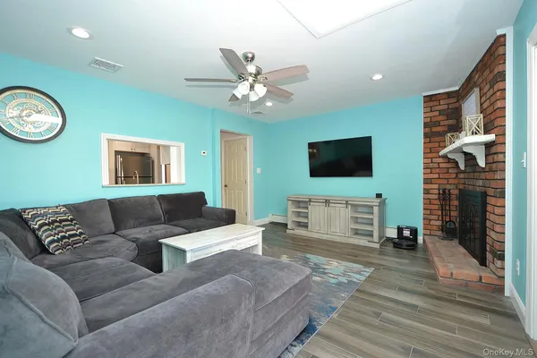 a kitchen with stainless steel appliances granite countertop a stove top oven a sink a dining table and chairs