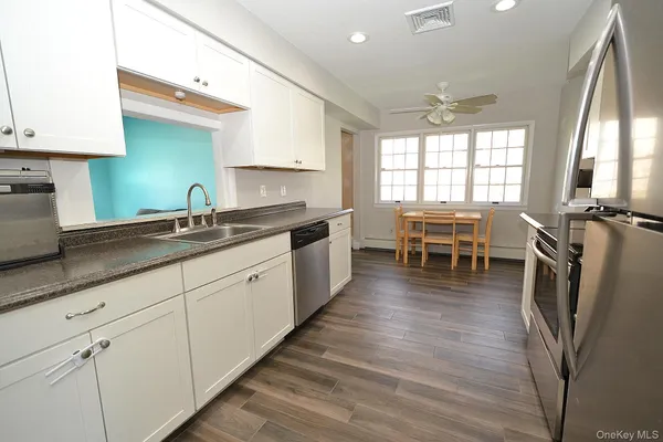 a kitchen with a stove a sink and a refrigerator