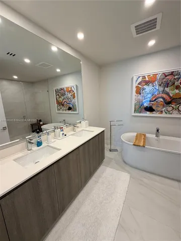 a bathroom with a sink a bathtub and a shower