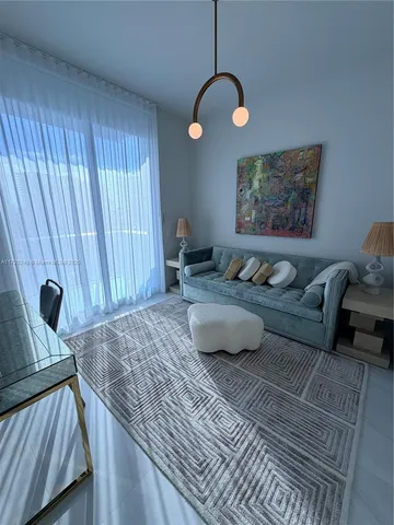 a view of a livingroom with furniture and bathroom