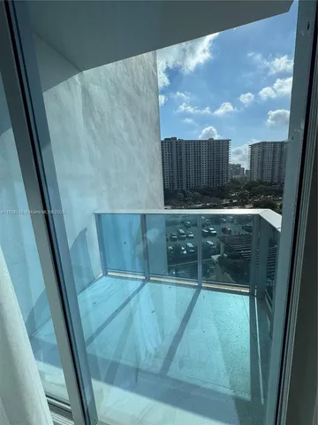 a view of a balcony with two chairs and a table