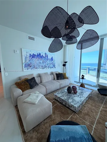 a living room with furniture rug and window