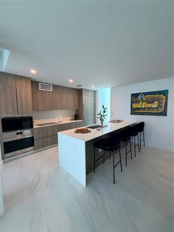 a kitchen with stainless steel appliances granite countertop a sink counter space and cabinets