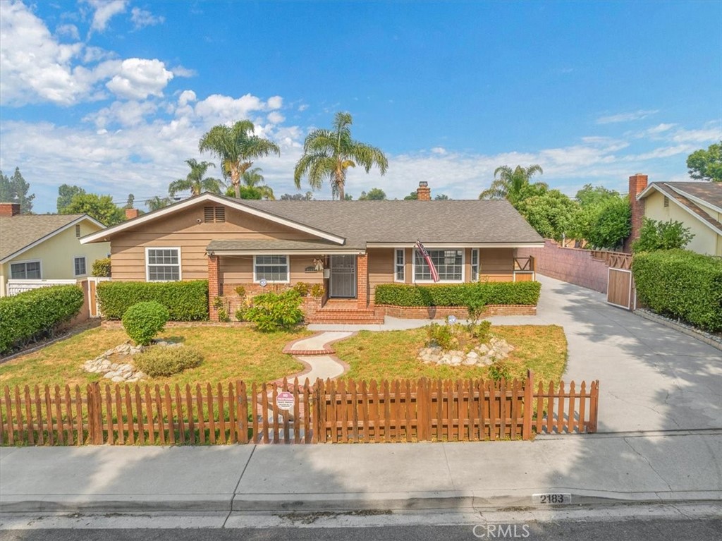2183 Sinclair Street Pomona, CA 91767 - Photo 2 of 38 a front view of a house with a yard