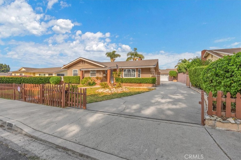 2183 Sinclair Street Pomona, CA 91767 - Photo 3 of 38 a view of a white house with a yard