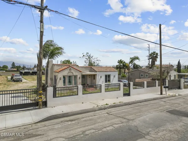 a view of a house with a iron fence