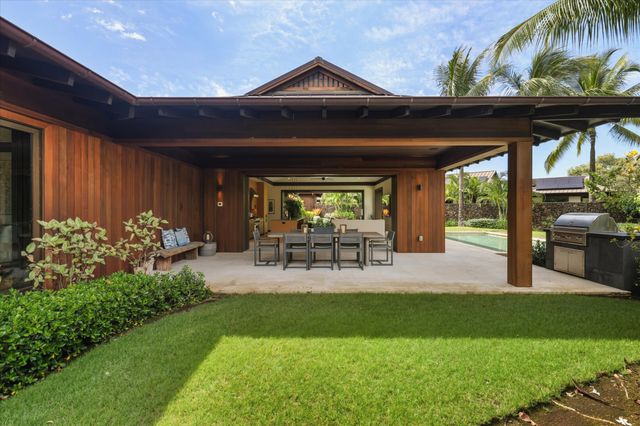 a view of a porch with chairs and plants