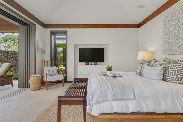a bedroom with a bed and glass door