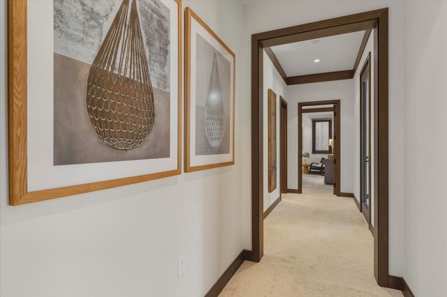 a view of a hallway to a livingroom with entryway