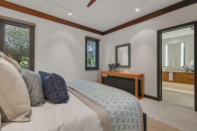 a bedroom with a large bed and a dresser