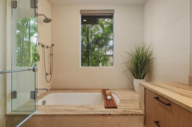 a bathroom with a tub shower and sink