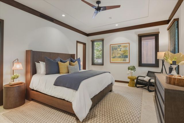 a bedroom with a large bed couch and a window