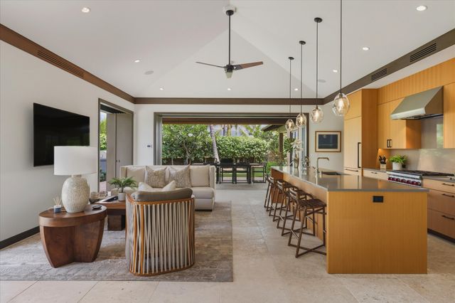 a living room with furniture a flat screen tv and a large window