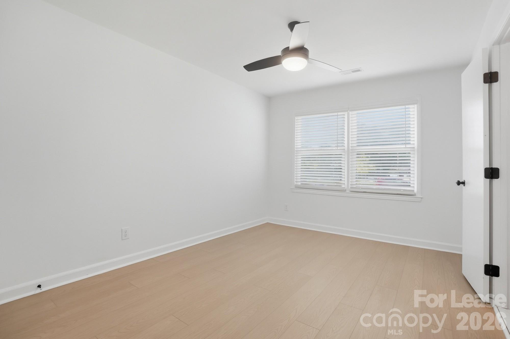 318 Hollis Road Charlotte, NC 28209 - Photo 11 of 30 wooden floor in an empty room with a window