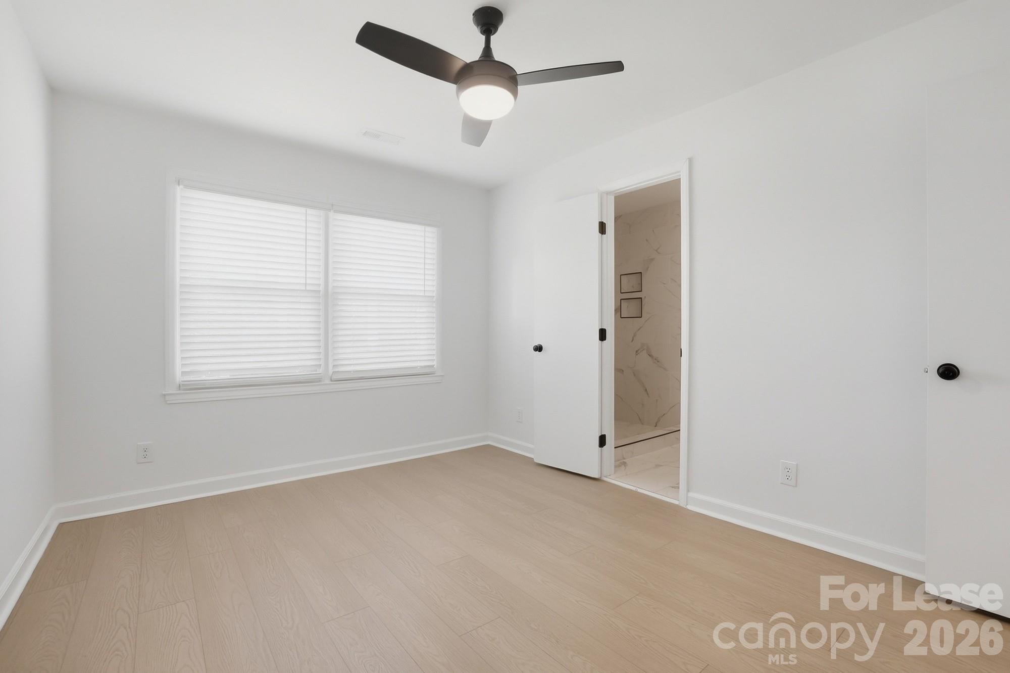 318 Hollis Road Charlotte, NC 28209 - Photo 12 of 30 an empty room with fan and windows