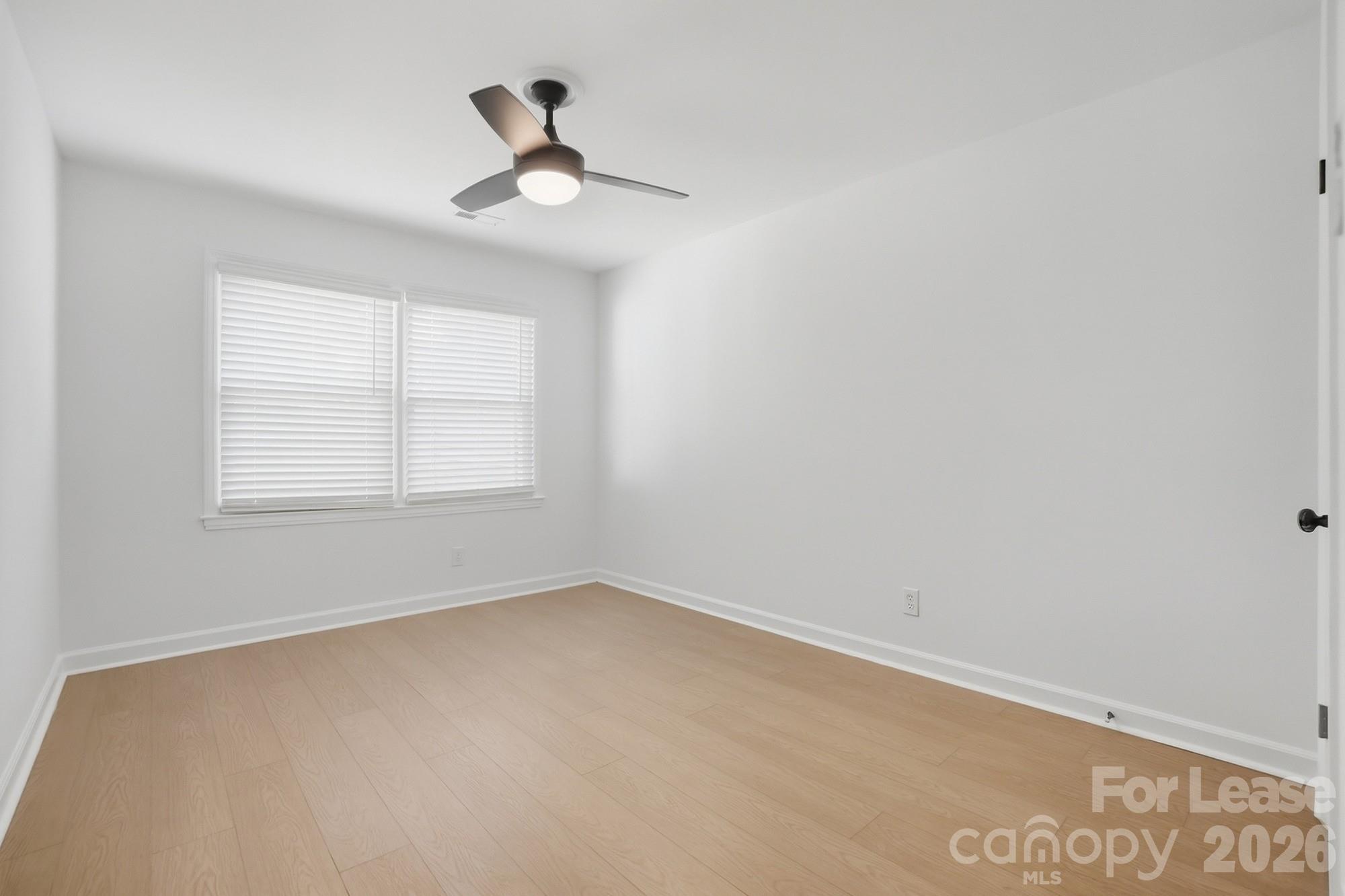 318 Hollis Road Charlotte, NC 28209 - Photo 17 of 30 an empty room with ceiling window and ceiling fan