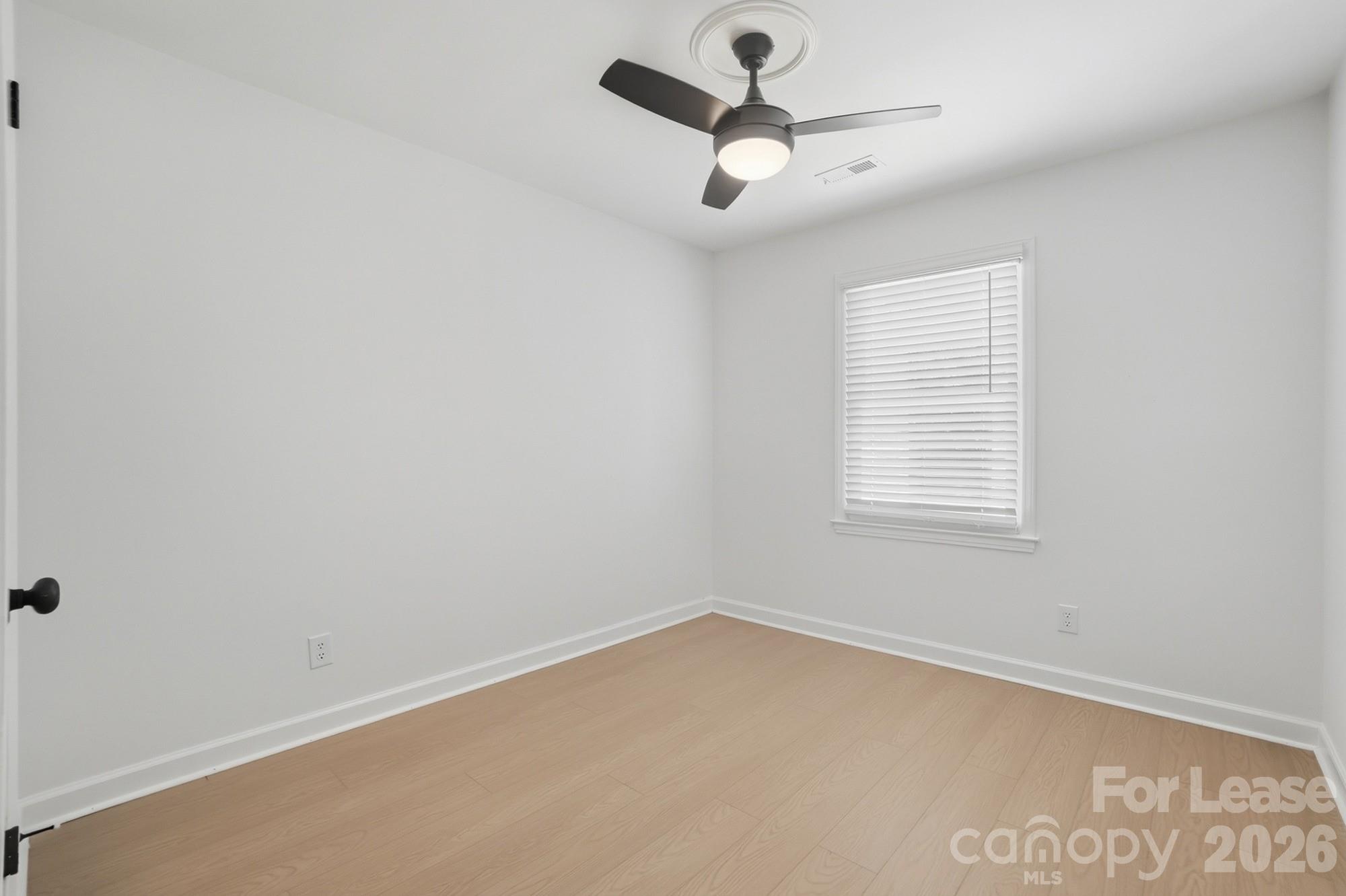 318 Hollis Road Charlotte, NC 28209 - Photo 23 of 30 an empty room with a window and a fan