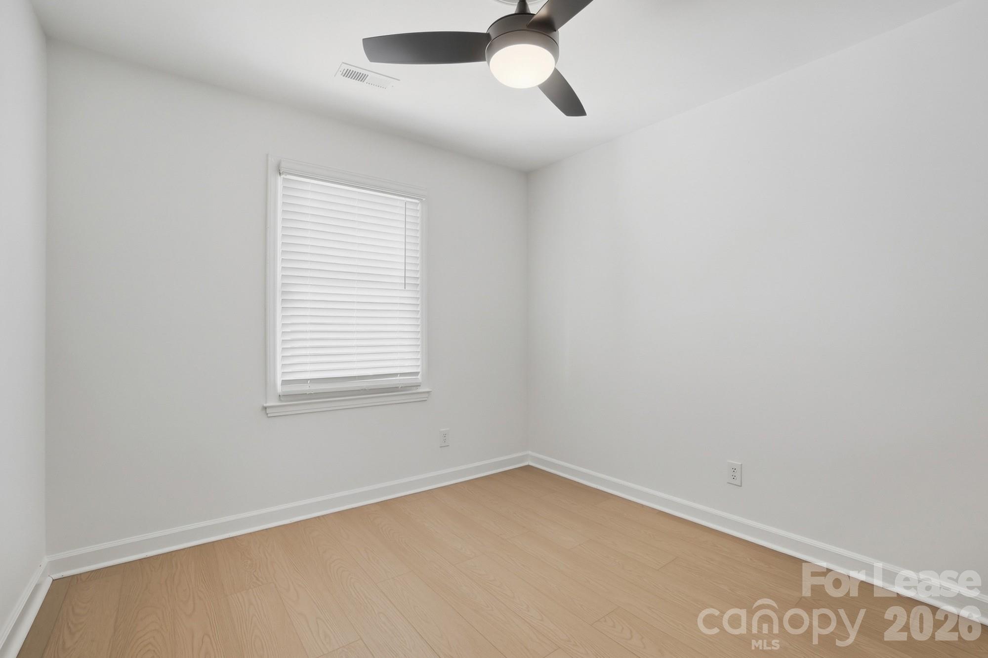 318 Hollis Road Charlotte, NC 28209 - Photo 24 of 30 an empty room with a window and a fan
