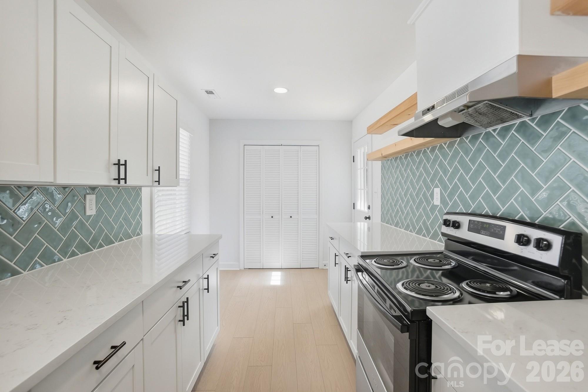 318 Hollis Road Charlotte, NC 28209 - Photo 6 of 30 a kitchen with a stove and a sink