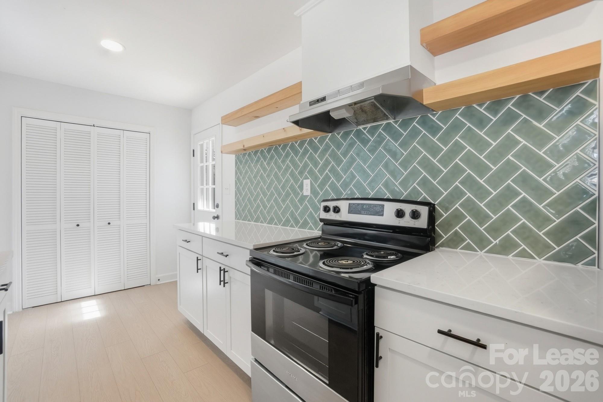 318 Hollis Road Charlotte, NC 28209 - Photo 7 of 30 a kitchen with cabinets and a stove top oven