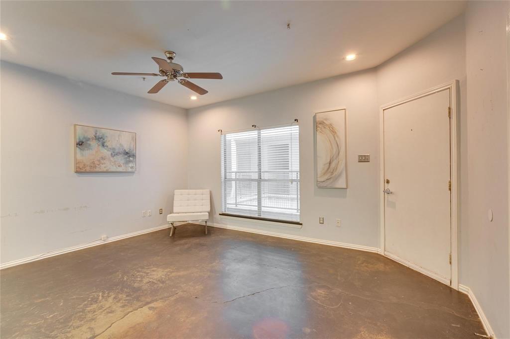 4104 North Hall Street, Unit 102 Dallas, TX 75219 - Photo 9 of 18 Spacious room featuring concrete-finish flooring, a ceiling fan with integrated lighting, recessed lighting, and a window with blinds