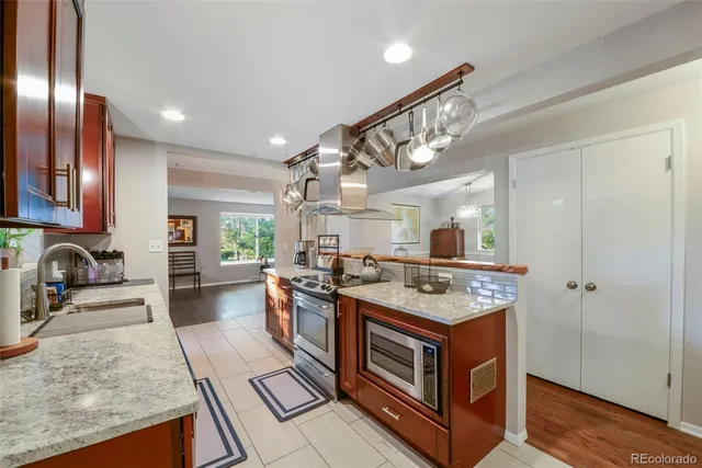 a kitchen with stainless steel appliances granite countertop a stove and a sink
