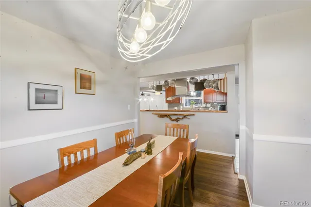 a dining room with furniture and wooden floor