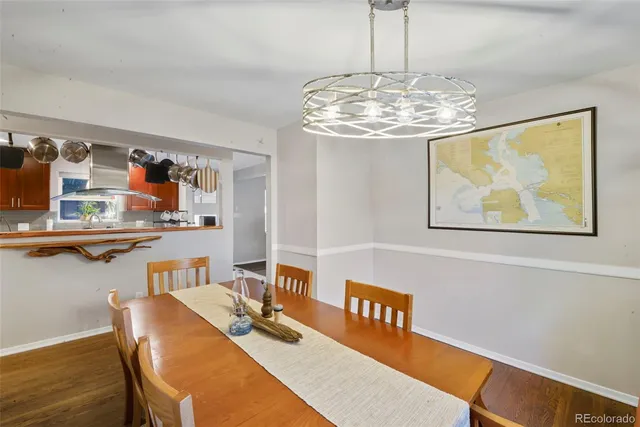 a view of a dining room with furniture wooden floor and chandelier