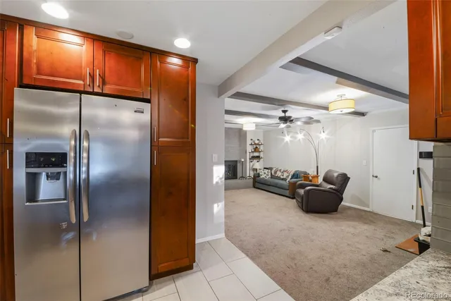 a kitchen with refrigerator and couch