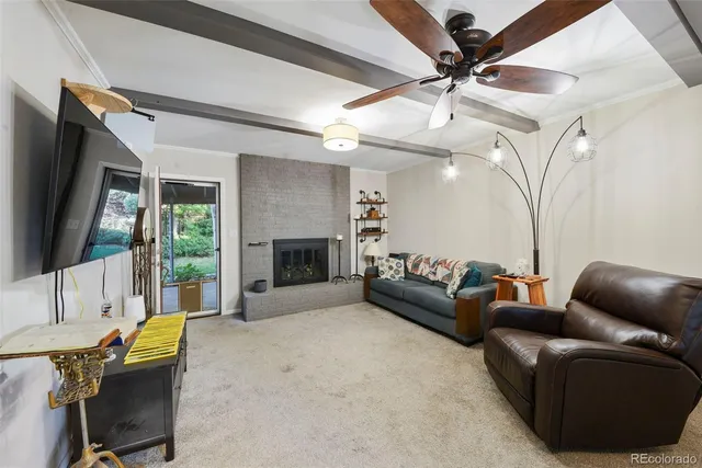 a living room with furniture a flat screen tv and a fireplace