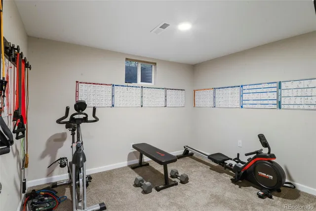 a room with gym equipment and a flat screen tv