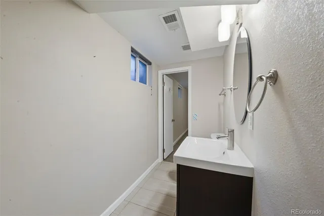 a bathroom with a sink and mirror