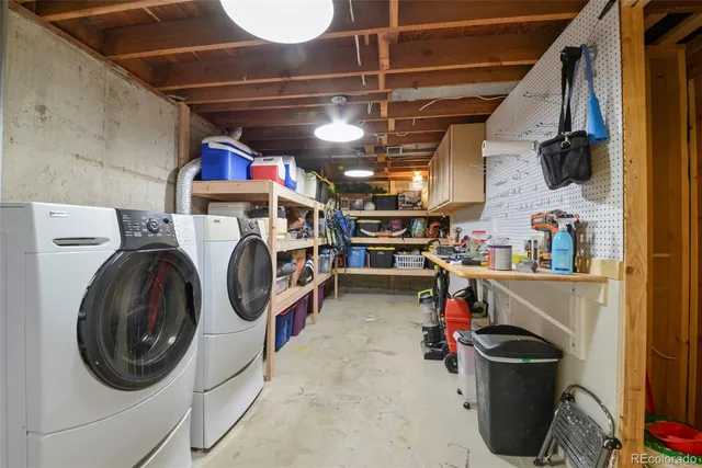 a utility room with dryer washer and other items